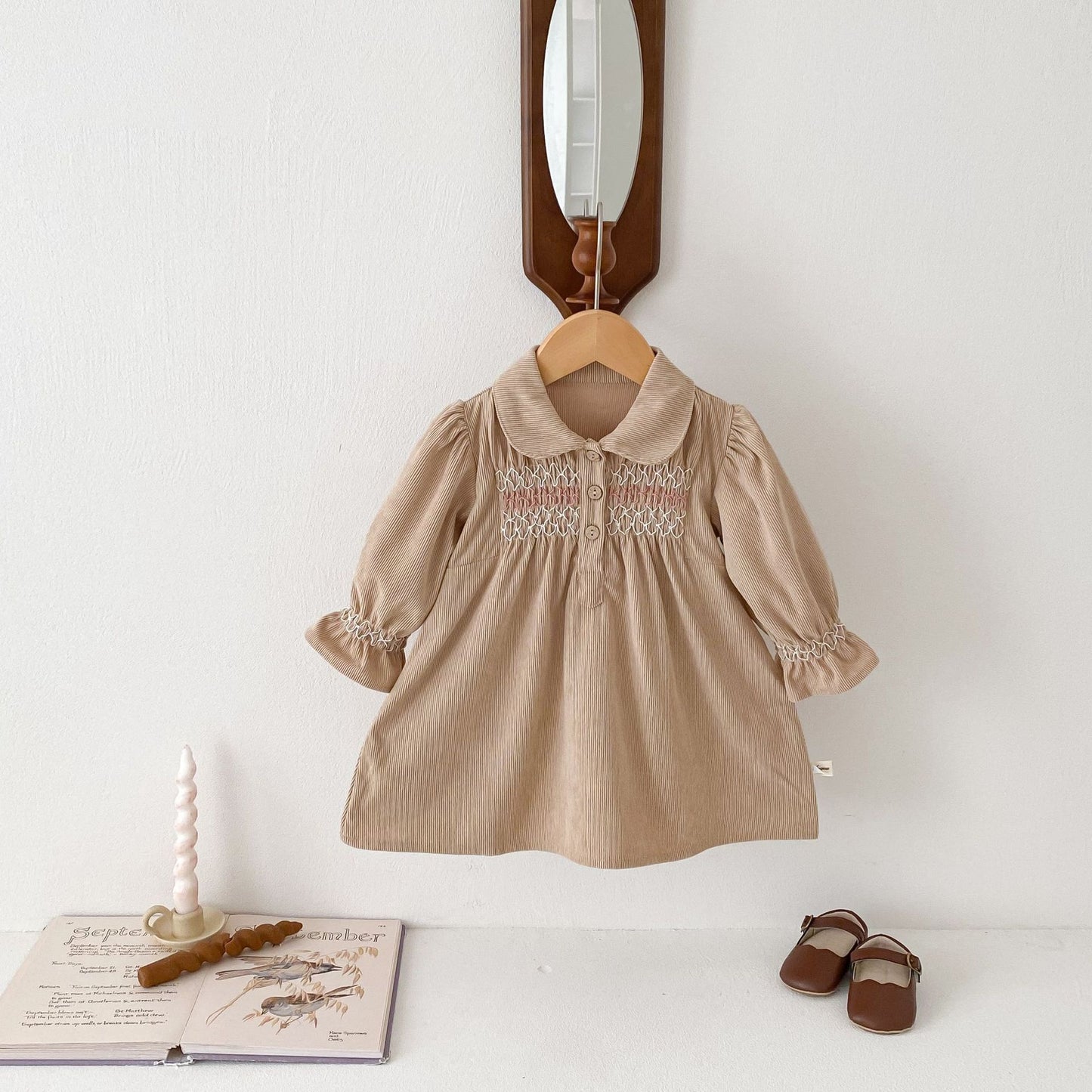 Acorn Smocked Dress in Oat, styled on hanger
