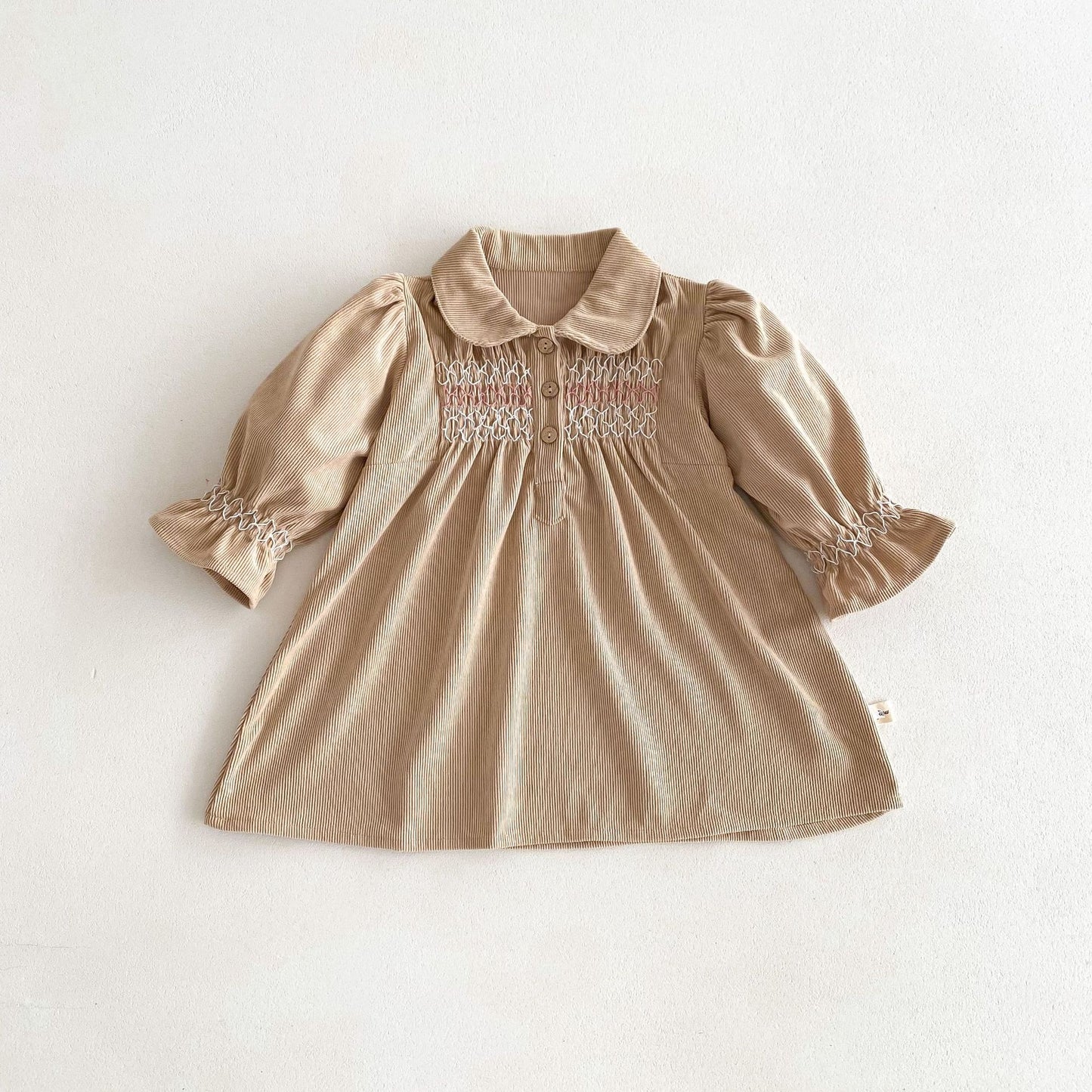 Acorn Smocked Dress in Oat corduroy, flat lay