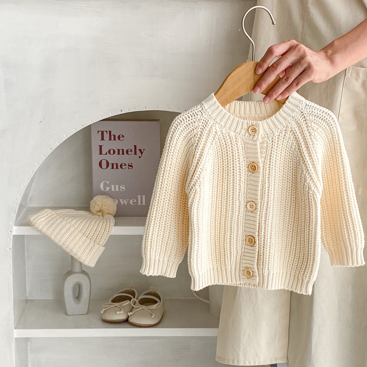 Willow Oat Cardigan on wooden hanger